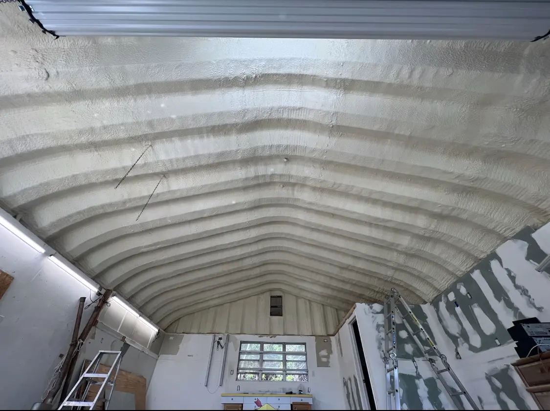 Spray polyurethane foam applied to the underside of a metal roof deck in Cocoa